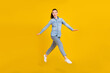 © deagreez - Full length photo of cute excited young woman wear denim shirt smiling jumping high isolated yellow color background