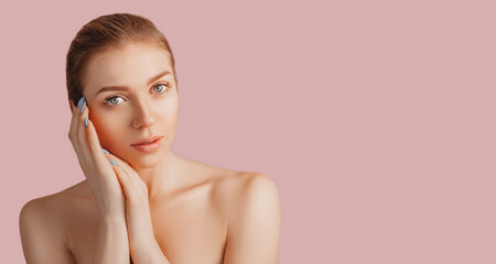 Wall Mural - beautiful sensual young girl with clean skin on a pink background with a mockup. topless woman. the 