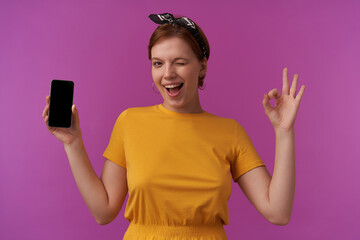 Wall Mural - Image of european young woman wearing stylish trendy summer clothes and bandana with natural makeup posing against purple wall emotion stressed scream with eyes closed on the phone furious