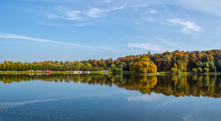 Panoramic view of Tsaritsyno autumn Park, with reflections of trees in the lake. Moscow.