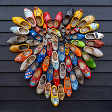 Close Up View Of Many Colorful Traditional Clogs Hanging On The Wall Of A House In The Netherlands
