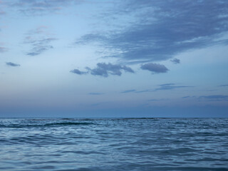calmful ocean beach dusk with deep blue sky and breezing waves.