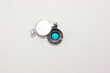 Home door peephole with metal lid cover white wood background macro close up shot