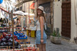 picture from the back of a young tourist exploring a typical italian market in Palermo