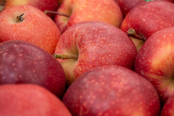 Photo on the theme of fruit. Boxes of juicy apples in the supermarket.