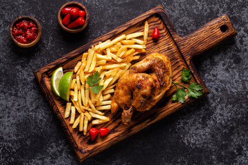 Wall Mural - Half roasted chicken Piri Piri with french fries