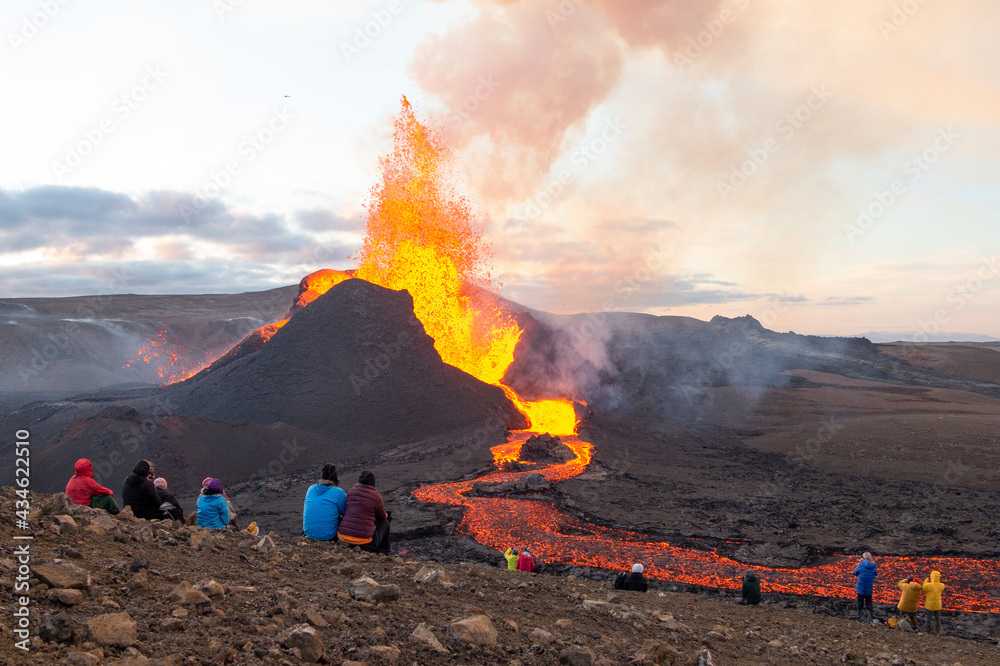 GELDINGADALIR, ICELAND - 11 MAY, 2021: A small volcanic eruption started at the Reykjanes peninsula. The event has attracted thousands of visitors who have braved a daring hike to the crater. - obrazy, fototapety, plakaty 
