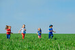 © davit85 - Running kids in green field during summer.