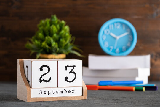 Wall Mural - September 23rd. September 23 wooden cube calendar with blur objects on background.