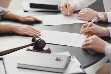 Wall Mural - Couple signing divorce decree in lawyer's office