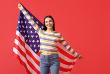 Beautiful Young Woman With USA Flag On Color Background