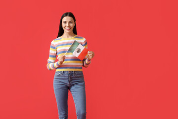 Beautiful young woman with Mexican flag on color background