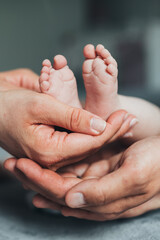 newborn baby feet in parents hands