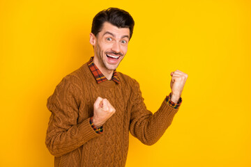 Canvas Print - Photo of excited young guy raise fists open mouth wear brown sweater isolated bright yellow background