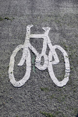 White Painted Cycle Sign on Rough Grey Road Surface