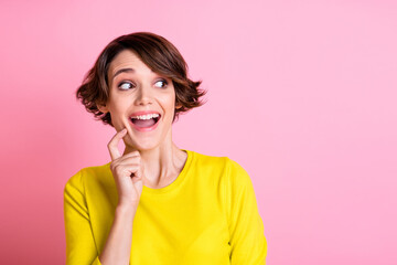 Poster - Photo of young happy positive excited pretty girl thinking look copyspace hold finger on chin isolated on pink color background