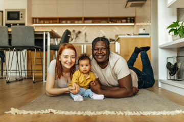 Portrait of a happy diverse family relaxing at home.