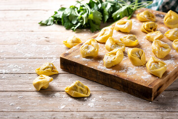 Uncooked pelmeni dumplings on rustic wooden table. typical russian food	