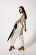 © SHOTPRIME STUDIO - woman holding an umbrella in her hands fashion white suit studio modern style