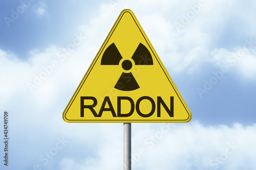 Danger of radioactive contamination from RADON GAS - concept with warning symbol of radioactivity on road sign - image with copy space