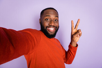 Wall Mural - Self-portrait of attractive funny cheerful guy having fun showing v-sign isolated over violet purple pastel color background