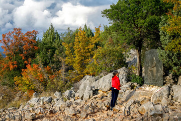 Wall Mural - Pilgrim praying on the hill of apparitions, Podbrdo, Medjugorje, Bosnia and Herzegovina