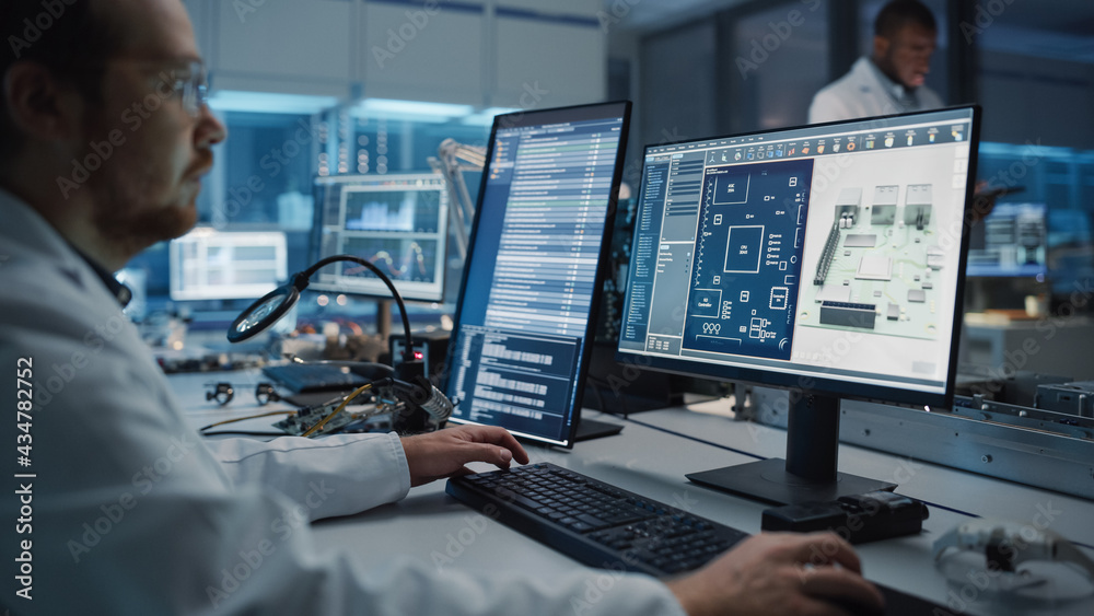 Modern Electronics Facility: Scientist, Engineer Works on Computer with ...