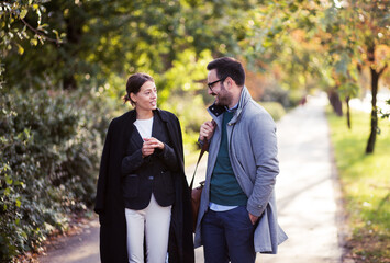 Business colleagues walking in the park after work