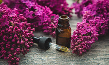 Lilac Essential Oil In A Small Bottle. Selective Focus.