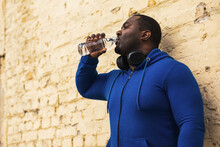 Sporty  Man Drinking Water Outdoor.