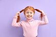 © alfa27 - Cheerful Kid Girl Have Fun, Holding Two Tails In Hands, Smiling At Camera, Happy Excited Child With Natural Red Hair