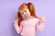 © alfa27 - I don't know. redhead child girl shrugging, misunderstanding, look at camera, having no information about something. isolated purple background