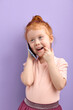 © alfa27 - redhead kid girl talking on phone indoors. concept of addiction of children and gadgets. kid girl using gadget, bad habits of younger generation, parental control, restricting content and access