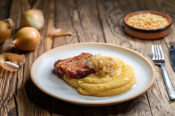 Wall Mural - Czech cuisine, smoked meat with pea porridge and fried onion until golden