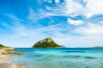 Poster - Sunning view of Figarolo island bathed by a turquoise water during a sunny day. Figarolo is an Italian island within the Gulf of Olbia at Golfo Aranci, in north-eastern Sardinia, Italy.