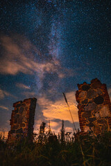 milky way, starry sky. clouds covering up the sky, old ruins. destroyed mill