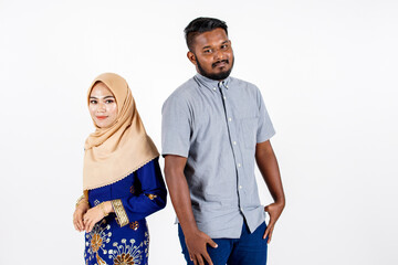 Studio portrait of Muslim Asian couple in a feast day with a white background. Fashion for dinner, event and feast day. Studio shot with white background.