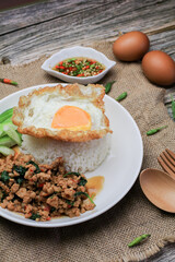 Wall Mural - Thai Stir fried  basil with minced pork, chili and fried egg on topped rice. Thai local food style call 