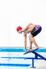 Wall Mural - Young Paralympic Athlete Ready To Jump Into The Pool During A swimming training with hand hypoplasia in disability concept in Latin America