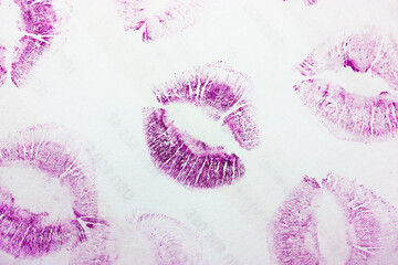 Abstract purple kisses isolated on white background. Lots of lip prints on paper