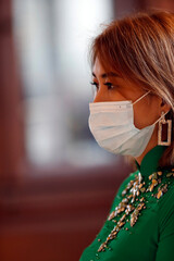 Canvas Print - Tu An vietnamese buddhist pagoda. Woman wearing surgical mask. Covid 19 pandemic.  Saint Pierre en Faucigny. France.