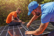 Workers assemble energy system with solar panel for electricity and hot water