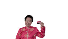 Chinese New Year Spending Credit Card. Asian Senior Woman In Constume Holding Red Card