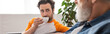 © LIGHTFIELD STUDIOS - Man with cup looking at blurred father at home, banner