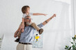 © LIGHTFIELD STUDIOS - Smiling granddad and boy gesturing at home
