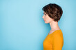 © deagreez - Profile portrait of nice serious brunette lady look empty space wear yellow shirt isolated in vivid blue color background