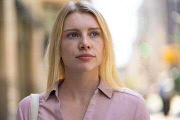 Poster - Young caucasian woman in city