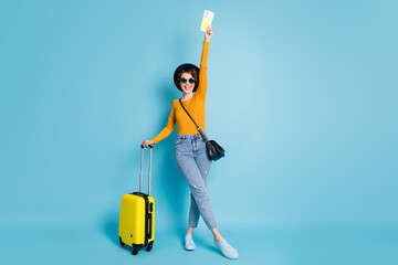 Poster - Full length body size photo girl keeping documents tickets in airport terminal ready to travel isolated on bright blue color background