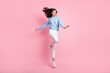 © deagreez - Full length photo of funny lady jump look empty space wear blue sweater isolated pink color background