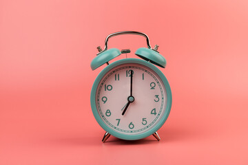 Old clock isolated on a pink background with space for text. Concept of time